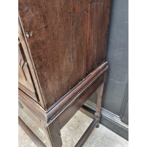 1063 - An antique oak geometrically moulded chest on stand, 102.5cm wide.