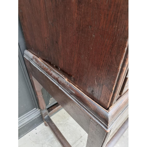 1063 - An antique oak geometrically moulded chest on stand, 102.5cm wide.