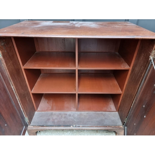 1064 - An antique mahogany side cabinet, the pair of cupboard doors simulating drawers, 108.5cm wide.... 