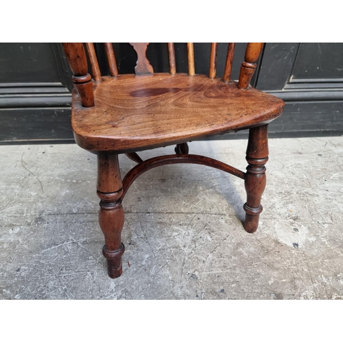 1070 - A scarce 19th century yew, elm and fruitwood childs' Windsor armchair.