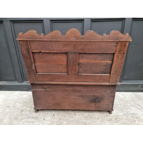 1073 - A circa 1900 carved oak box seat settle, 106cm wide. 