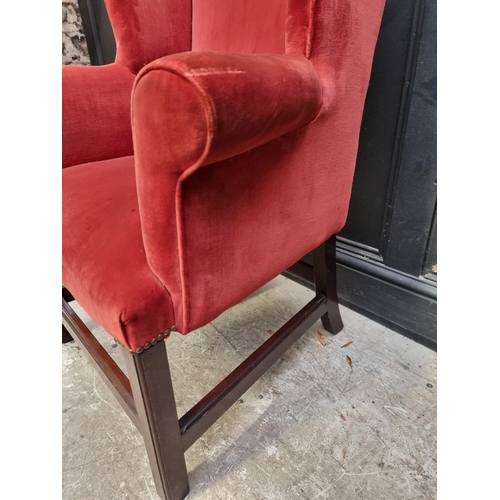 1075 - A small antique mahogany wing armchair. 