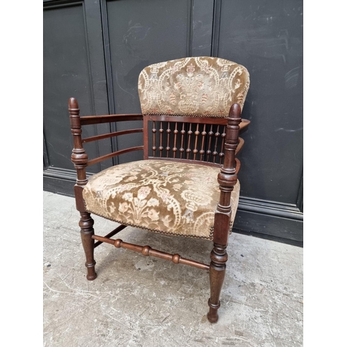 1076 - An unusual Edwardian mahogany and upholstered tub armchair. 