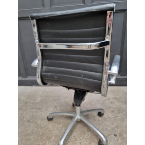 1084 - A contemporary chrome and black leather desk chair.