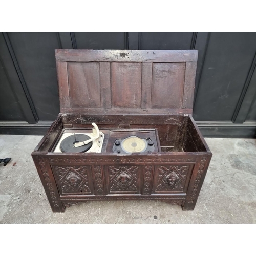 1094 - An interesting late 17th century carved oak panelled coffer, the front incorporating three stylised ... 