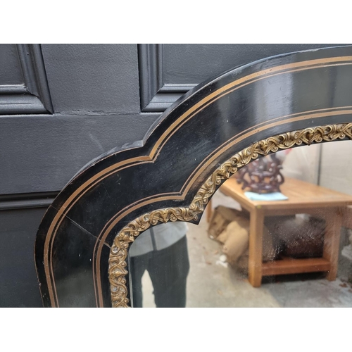 1096 - A large ebonzied and gilt brass framed mirror, 137 x 83cm.