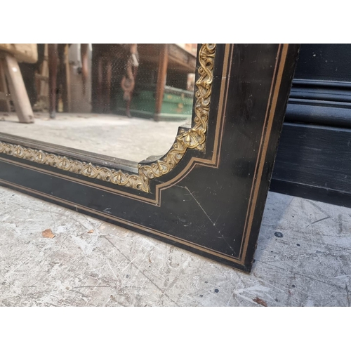 1096 - A large ebonzied and gilt brass framed mirror, 137 x 83cm.