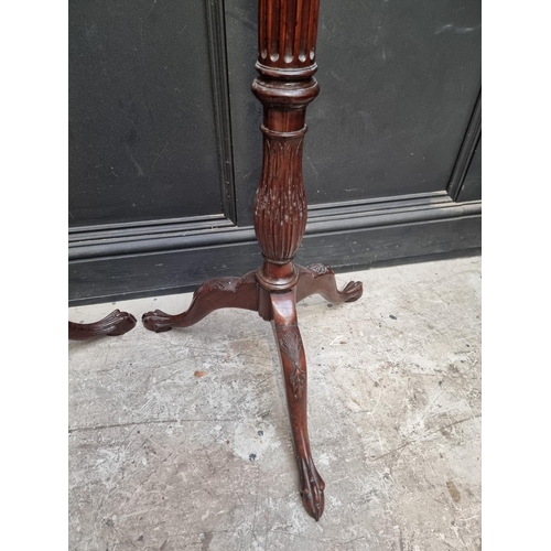 1109 - A pair of mahogany 'bedpost' tripod torcheres, 143.5cm high. (2)