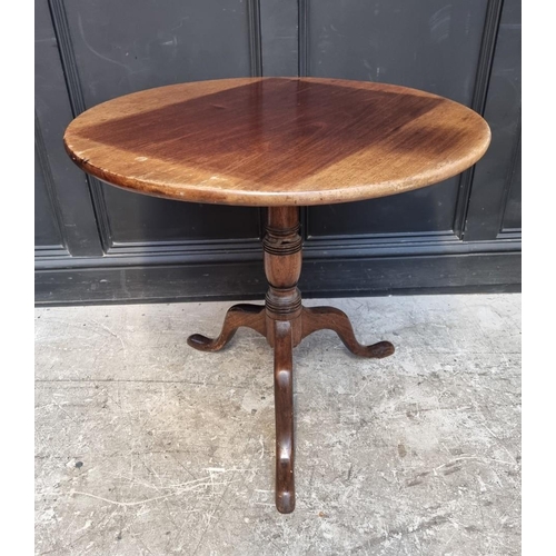 1111 - A George III mahogany circular tilt-top tripod table, 77cm diameter.