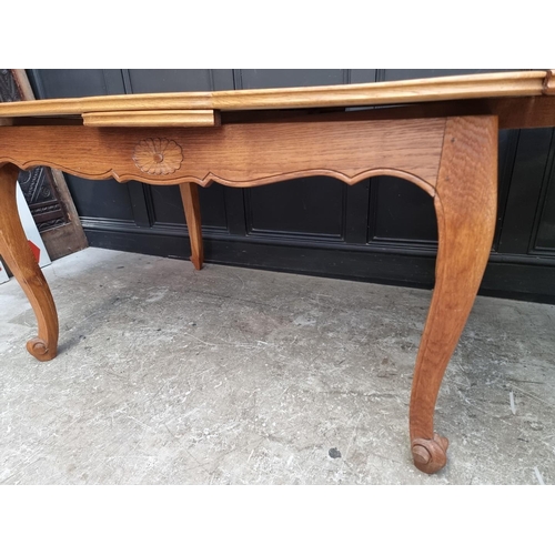 1114 - An oak draw leaf dining table, with parquetry top, 130cm when closed.