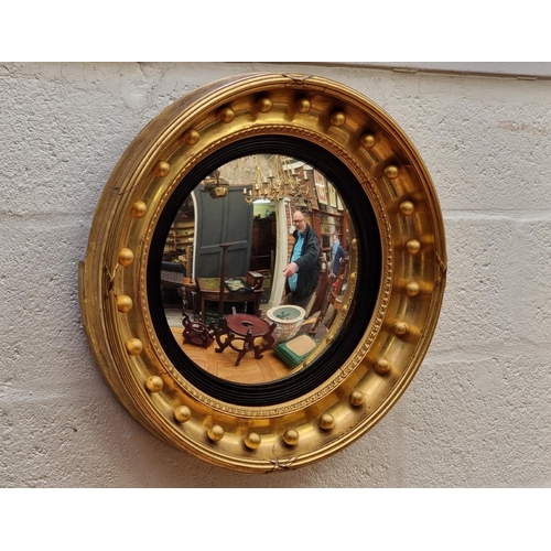 1118 - A 19th century gilt convex wall mirror, 56.5cm diameter.