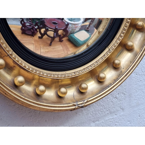 1118 - A 19th century gilt convex wall mirror, 56.5cm diameter.