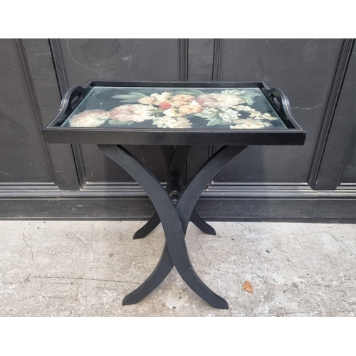 1119 - An ebonized butler's tray, on conforming folding stand, 61cm wide.