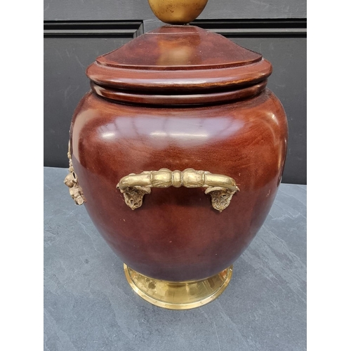 1138 - A turned wood and brass mounted twin handled jar and cover, 46cm high.