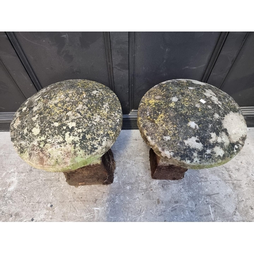 1176 - A near pair of old weathered sandstone staddle stones, 70cm high.