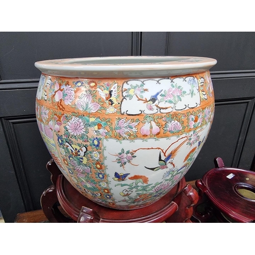 1179 - A Chinese famille rose fish bowl, 37.5cm diameter, on two concentric stands, total height 83cm.... 