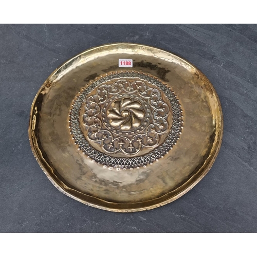 1188 - An antique embossed brass alms type dish, 36cm diameter.