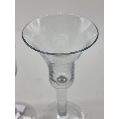 1253 - Two antique plain stem wine glasses, 16.5cm and 14cm high respectively.