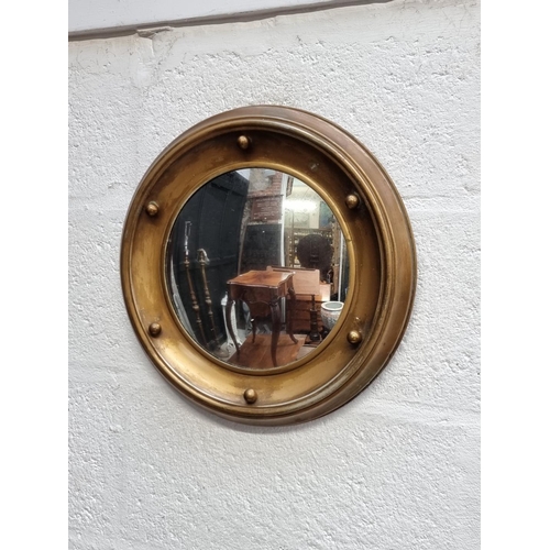 1275 - A brass framed circular wall mirror, 38cm diameter.