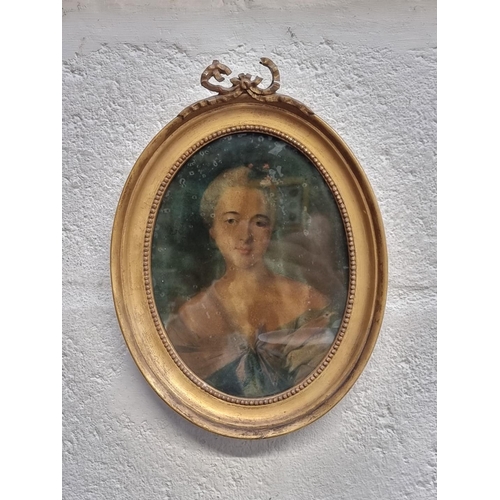 1318 - An antique reverse glass portrait of a lady, 19.5 x 14.5cm oval.