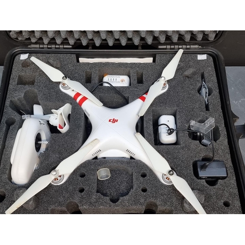 1328 - A DJI 'Phantom 2 Vision+' drone, with two batteries, charger, and controller, in fitted travel case,... 