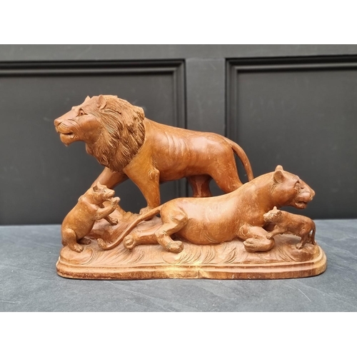 1329 - A large carved wood figure group of lions, 52cm wide.