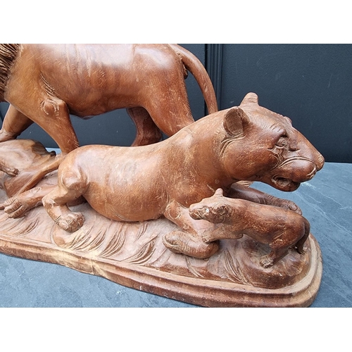 1329 - A large carved wood figure group of lions, 52cm wide.