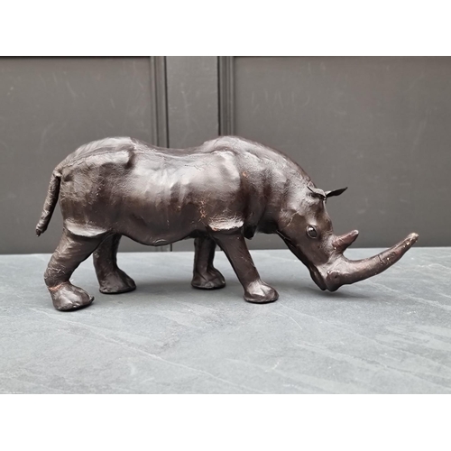 1331 - A small vintage leather Rhinoceros, in the manner of Liberty, with glass inset eyes, 52cm long.... 