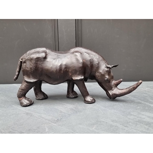 1331 - A small vintage leather Rhinoceros, in the manner of Liberty, with glass inset eyes, 52cm long.... 