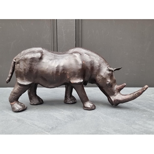 1331 - A small vintage leather Rhinoceros, in the manner of Liberty, with glass inset eyes, 52cm long.... 