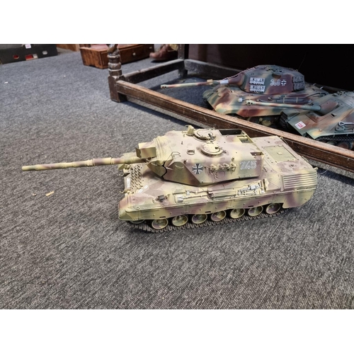 1339 - Five remote control tanks, to include: examples by Tamiya, largest approx. 65cm long, with four remo... 