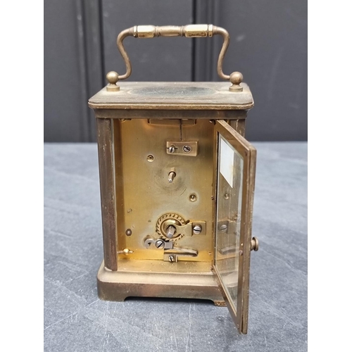 1345 - An old brass carriage timepiece, height including handle 13.5cm.