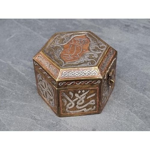 1351 - An Islamic Cairoware hexagonal casket, with script to hinged top, 10cm wide.