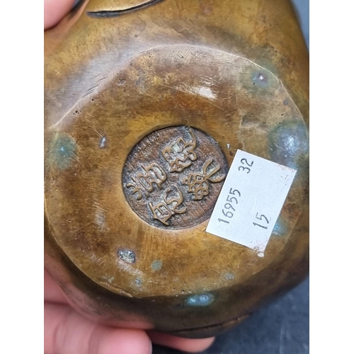 1354 - A Japanese bronze or brass 'Four Faces of Buddha' paperweight, 12.5cm high.