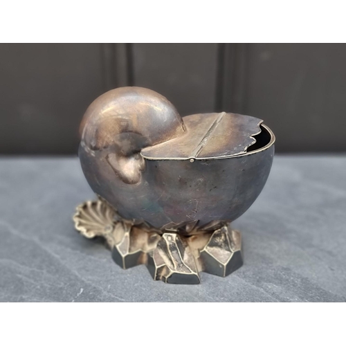 1389 - A Victorian electroplated nautilus shell spoon warmer, 14cm high, together with a cast brass framed ... 