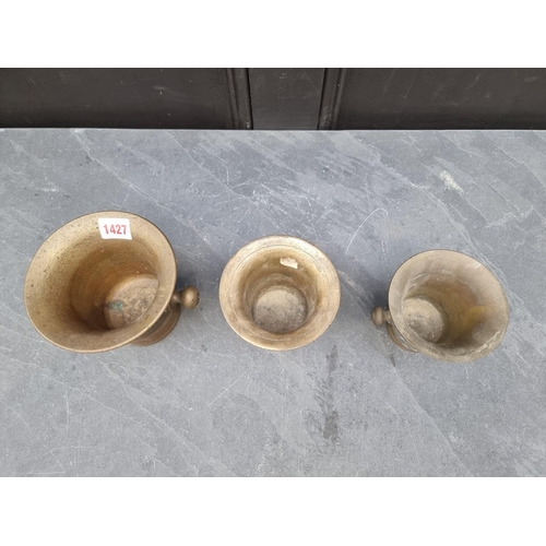 1427 - Three antique brass twin handled mortars, largest 12.6cm high x 14.2cm diameter. (3)... 