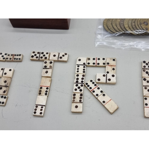 1452 - A collection of Napoleonic prisoner-of-war carved bone dominos, teetotums etc.