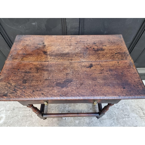 1061 - An early 18th century oak single drawer side table, 77.5cm wide.