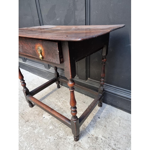 1061 - An early 18th century oak single drawer side table, 77.5cm wide.