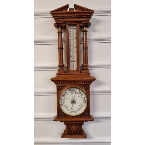 1521 - A late Victorian carved oak aneroid barometer, 92cm high.