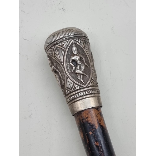 1527 - A Thai or Eastern ebonized and silver mounted cane. 