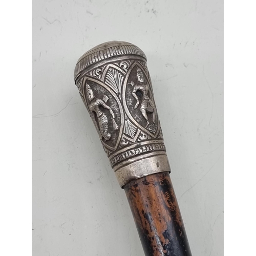 1527 - A Thai or Eastern ebonized and silver mounted cane. 