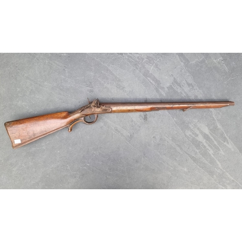 1539 - A circa 1800 muzzle loading double barrel flintlock shotgun, having carved walnut stock and 60cm bar... 