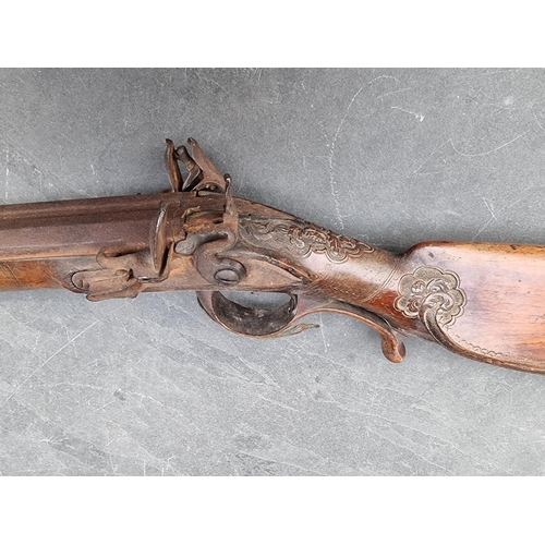 1539 - A circa 1800 muzzle loading double barrel flintlock shotgun, having carved walnut stock and 60cm bar... 