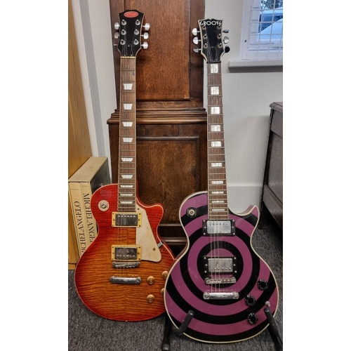 1553 - A cherry red sunburst 'Les Paul' style electric guitar, by Stagg; together with another electri... 