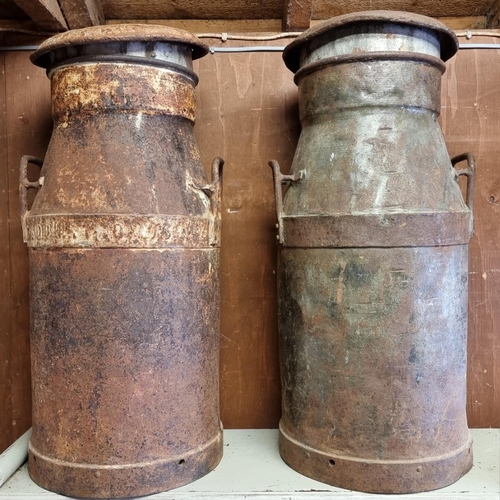 1559 - Two large old metal milk churns, inscribed 'Cadbury Bros Ltd', 75cm high.