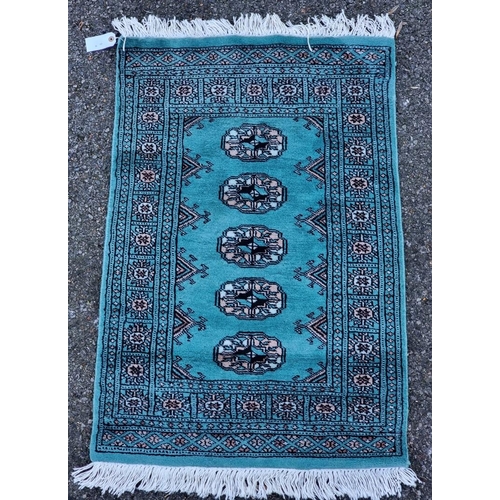 1571 - A small Bokhara style prayer rug, having four central medallions, 106 x 63cm.