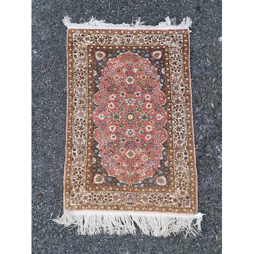 1581 - A small Persian silk rug, having allover floral decoration, 126 x 74cm.