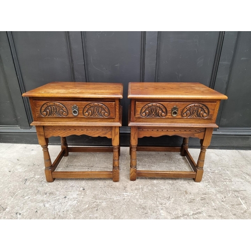 1007 - A pair of 'Old Charm' oak bedside tables, 56.5cm wide. (2)