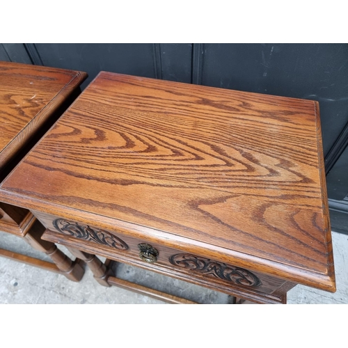 1007 - A pair of 'Old Charm' oak bedside tables, 56.5cm wide. (2)